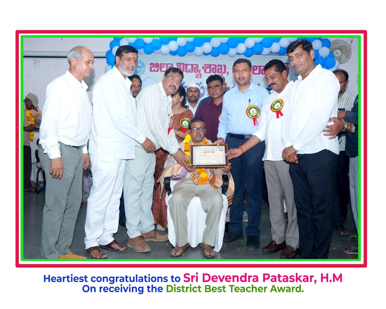 Headmaster Sri Devendra Pataskar receiving the District Best Teacher Award from district officials